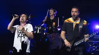 Matt Bellamy, Dominic Howard and Chris Wolstenholme on stage while performing