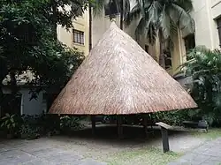 A model of an Ifugao house in the courtyard of the building