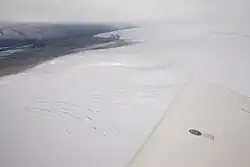 Ice covered Katla volcano, Iceland, in 2011, with hydrothermally or eruption caused ice cauldrons. The volcanic ash is from the 2010 eruptions at nearby Eyjafjallajökull volcano.