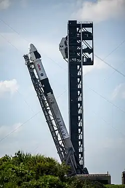 The strongback tilts the Falcon 9 rocket carrying the Crew Dragon Freedom to a vertical position at SLC-40