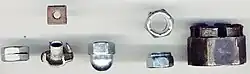 Left to right: Slotted, square (upper), T-nut (lower), cap (or acorn), nylon locking (top and side views), and castellated nuts.