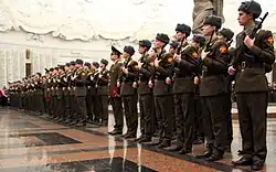 Present arms with AK-74s.