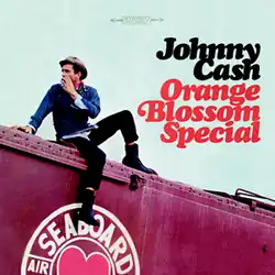 A man sits ontop of a Boxcar with the Seaboard Air Line logo. The words "Johnny Cash" and "Orange Blossom Special" appear aside in black and orange.
