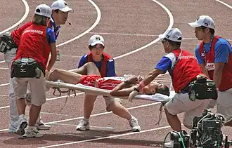 Japanese athlete is carried away after the 50 km walk.