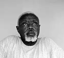 black-and-white portrait of an elderly African man with white hair and beard