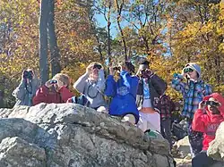 SCH students using binoculars at Wissahickon Creek