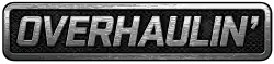 A simple logo spelling the word "Overhaulin'" in block capital letters in silver over what appears to be a car grill or interlaced gray mesh