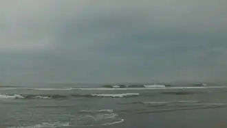 Ocean with breaking waves under a dark and stormy sky