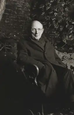 Head-and-shoulders portrait of Patrick Gibson wearing glasses