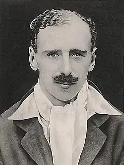 Headshot of a moustached man