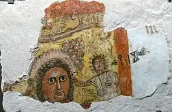 Fragment of a wall painting with a man's head and an Old South Arabian inscription, probably a banquet scene (1st/2nd century AD)