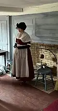 A period reenactor in the house's west parlor