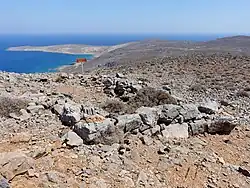 A three-sided stone room, in ruins, on a mountain-top