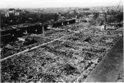 Black and white aerial photograph of a devastated urban area