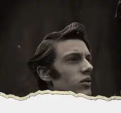 Black-and-white headshot of a young, clean-shaven, white man with a sharp jaw and styled pompadour hairstyle, facing right. The photograph has been digitally "torn up", only showing the subject above his neck.