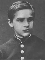 A black-and-white photograph of a young boy, looking towards the right