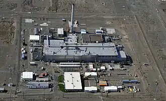 A color photograph which shows the multiple buildings of an industrial facility