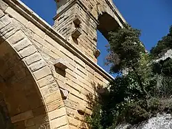 Stonework on the Pont du Gard, showing the protruding blocks that were used to support the scaffolding