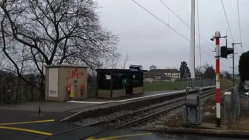 Single-track railway with a station platform and shelter