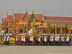 An officer supporting the urn of Princess Bejaratana Rajasuda on the Lord's Palanquin wears the Nobleman's Gown and the Lomphok, 10 April 2012.