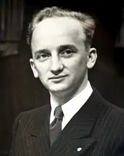 Black-and-white photograph of Ferencz, aged 27, wearing a black pinstriped suit and a dark tie