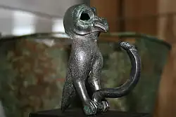 Photo of a bronze owl, part of a wine vessel ornament