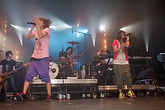 Yoshimura (left) and Ōnuki (right) performing as PUFFY at the 2009 Japan Expo at the Paris-Nord Villepinte Exhibition Centre