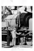 Tom Rasey and Paddy Whyte, MLAs, in front of a Garatt locomotive, 1950