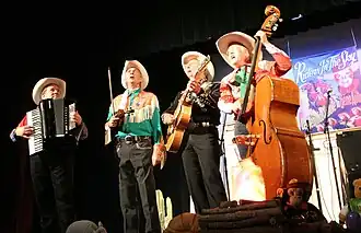 Riders in the Sky appearing at the Ponca Theatre in Ponca City, Oklahoma on September 29, 2007 at a concert commemorating the 100th anniversary of the birth of Gene Autry. From left to right are Joey the Cow Polka King, Woody Paul, Ranger Doug and Too Slim.