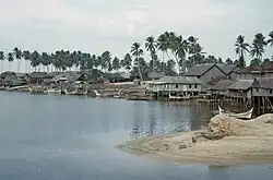 Huts by a river