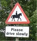 A pictographic traffic sign (top) warning motorists of horses and riders