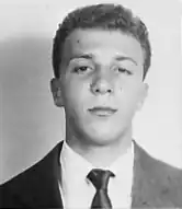 A black and white photograph of the clean-shaven face of a young man