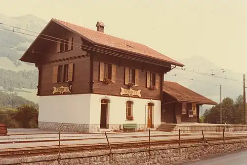 Three-story building next to a single-line track