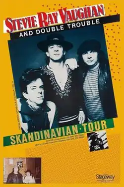 A yellow poster with a black-and-white image occupying most it. The image shows Stevie Ray Vaughan and Double Trouble staring at the viewer as Vaughan stands in the center with a slight smile on his face. Text on the poster reads "Stevie Ray Vaughan and Double Trouble Skandinavian Tour" and "Special festival appearance at Vossa Jazz Fri. 23. Albums Texas Flood CBS (Epic EPC 25534) New LP Couldn't Stand the Weather CBS (Epic EPC 25940)".