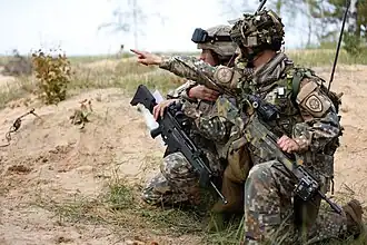 Latvian soldiers using a Heckler & Koch G36 rifle attached with Trijicon ACOG