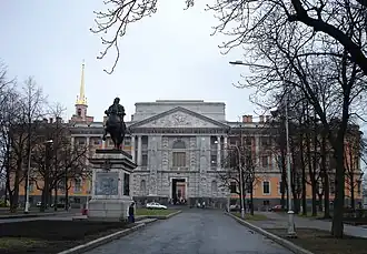 Road leading to a large orange-and-white building