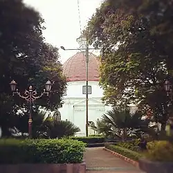Exterior of the Blenduk Church, blanketed by the trees at Srigunting Garden.
