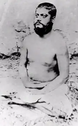 Image of Vivekananda, sitting in meditative posture, eyes opened