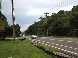 Eastbound Tennessee State Route 100 past the intersection with McCrory Lane and the interchange with the northern terminus of the Natchez Trace Parkway Pasquo