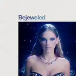 Cover art of "Bejeweled" showing Swift in intricate makeup glowing in the dark