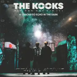 The Kooks standing on a stage with their backs to the viewer looking at a projection of outer space