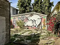 The reverse side of a building on Horizon Avenue features Jules Muck and Erik White.