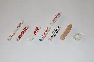 Smoking pipe filters. Left to right: 6 mm paper. 6 mm charcoal. 9 mm paper. 9 mm charcoal one-sided. 9 mm meerschaum. 9 mm balsa wood. Falcon dry ring.