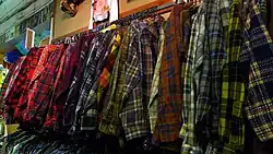 Clothing rack with very wide array of tartan flannel shirts