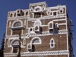 Closer view of a single tower house, showing the plaster decoration