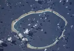 Satellite image of an atoll surrounding a central lagoon