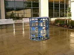 A defunct turnstile on paving outside a supermarket