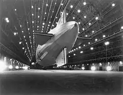 Macon showing its tail; unlike traditional rigid airship designs, the tail was not cruciform, with the stabilizers instead mounted onto the hull rings at the rear of the ship.