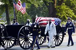 A caisson bearing the casket of former president Ronald Reagan proceeding down Constitution Avenue en route to the United States Capitol building