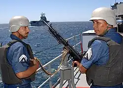 Mexican navy gunners prepare to fire an HK21